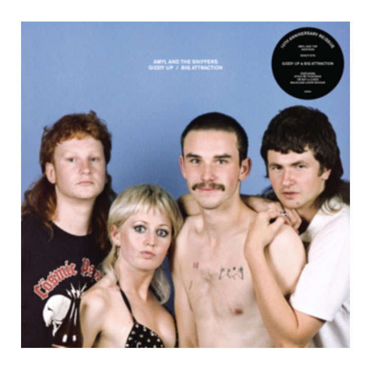 Album cover for Anty and the Skuffers' 'Ghosts of a Big Attraction', featuring four band members against a blue background with a black vinyl record sticker in the top right corner.