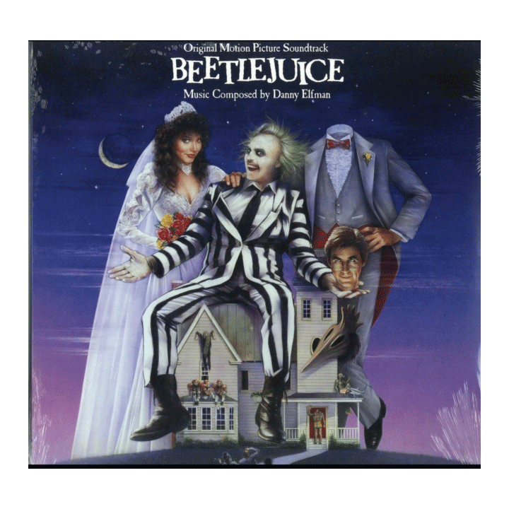 Beetlejuice cover featuring the ghost with the most sitting atop the house in the middle of the two main characters