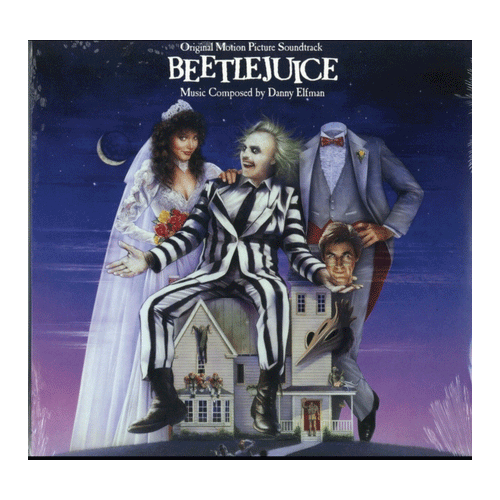 Beetlejuice cover featuring the ghost with the most sitting atop the house in the middle of the two main characters
