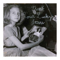 Black and white photo of a girl holding a book titled 'Thank Your Lucky Stars'. beach house
