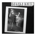 girl in picture on album cover, singing into a microphone. text 'bikini kill'