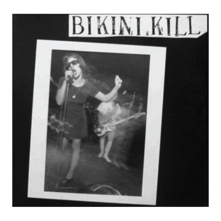 girl in picture on album cover, singing into a microphone. text 'bikini kill'