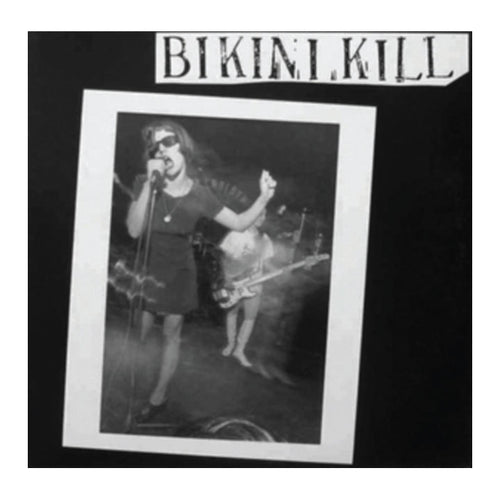 girl in picture on album cover, singing into a microphone. text 'bikini kill'