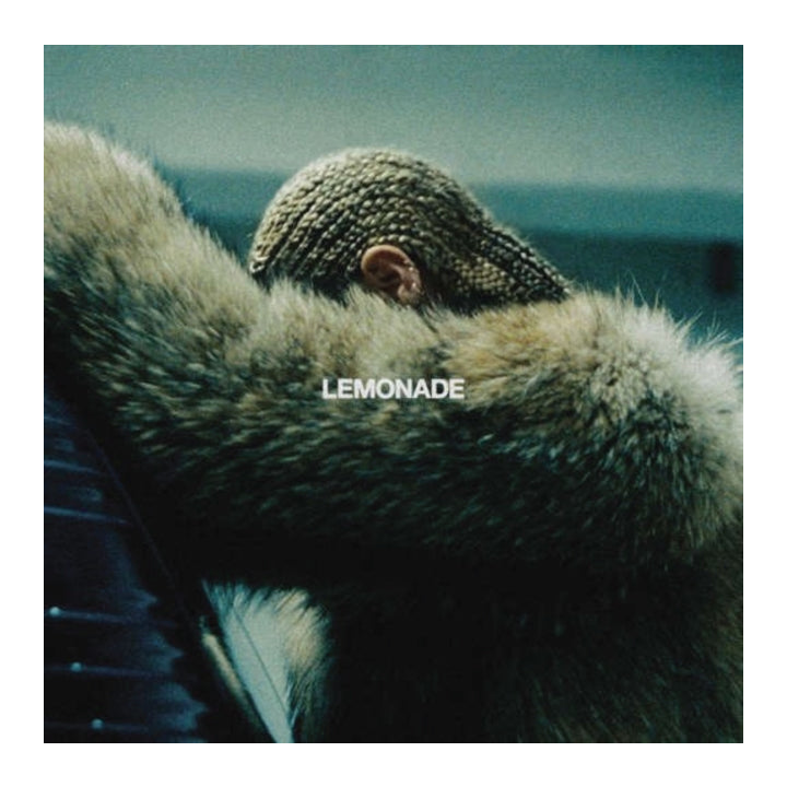 Album cover art for Lemonade, featuring a close-up of a person in a knit cap resting their head on a fur-lined surface, with the title 'LEMONADE' in white text across the center.