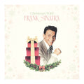Album cover for Frank Sinatra's 'Christmas With Frank Sinatra', featuring a portrait of the artist next to a stack of red and gold gift boxes on a decorated green wreath, set against a cream background with subtle snowflakes.