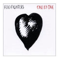 Album cover for 'One By One' by Foo Fighters featuring a black heart with white center.