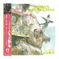 Japanese cover for Howl's Moving Castle, featuring the illustrated castle scene with the title in large yellow-green text and a pink spine band with Japanese text and a small record label logo.