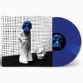 A vinyl record partially pulled from its sleeve, showing a blue record with a matching blue-and-black center label and cover art featuring white sculptural figures against a black-and-white perforated background.