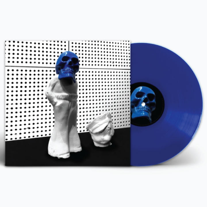 A vinyl record partially pulled from its sleeve, showing a blue record with a matching blue-and-black center label and cover art featuring white sculptural figures against a black-and-white perforated background.