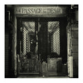 Vintage black and white photo of a door with 'Passage du Désir' sign above it.