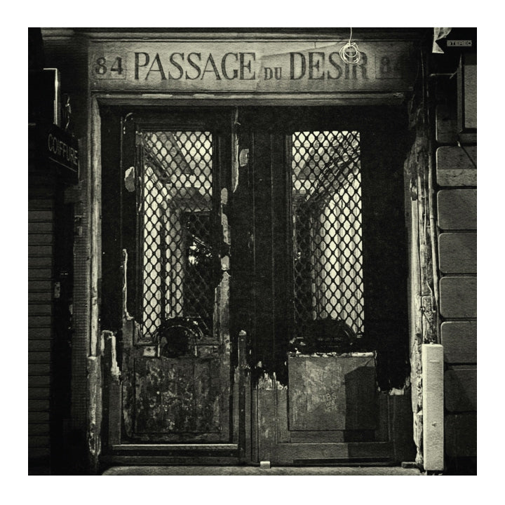 Vintage black and white photo of a door with 'Passage du Désir' sign above it.