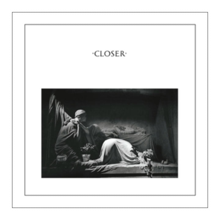 Album cover for 'Closer' with a black and white photo of two people lying on a bed.