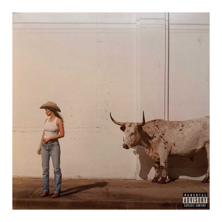 Album cover with a person in a cowboy hat and longhorn cow against a plain wall.