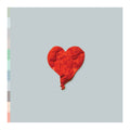 Red heart-shaped balloon on a light gray background