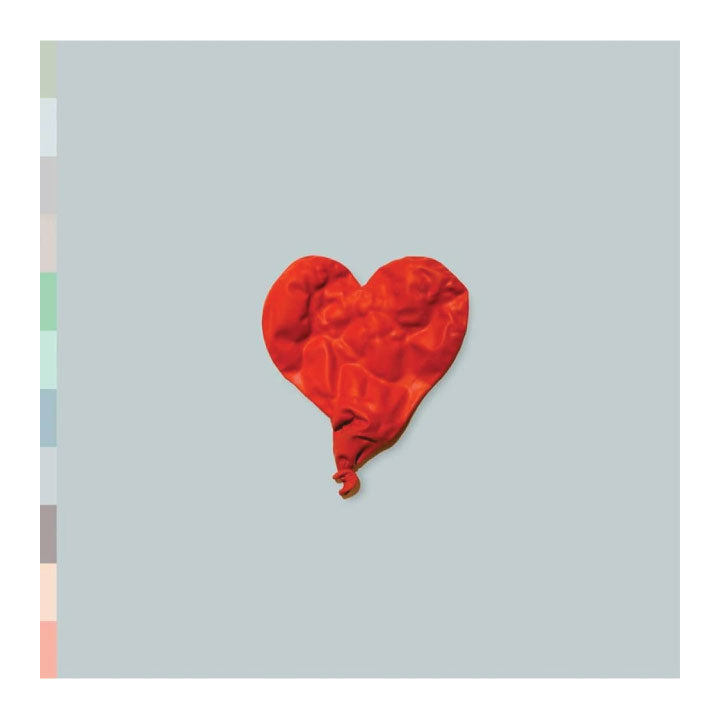 Red heart-shaped balloon on a light gray background