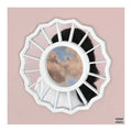 Album cover with a circular design featuring a landscape and black silhouette on a pink background