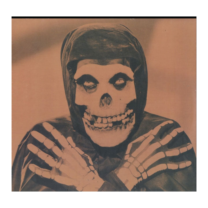 A sepia-toned portrait of a hooded figure with a skull face and skeletal hands, centered against a plain background.