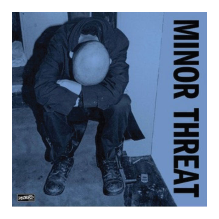 Album cover for 'Minor Threat' with a person crouching and text on a blue background