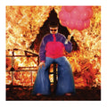 A stylized portrait of a person seated on a stool in front of a large fire, wearing a purple and pink jacket, blue wide-leg pants, and sunglasses, while holding a cluster of pink balloons.