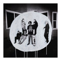 Black and white photo of a group of people inside a circular frame with text.