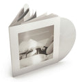 A vinyl record partially pulled from a slim white album case, with the record visible behind the cover. The cover features a monochrome photograph and the text 'THE FUTURED PORTS DEPARTMENT'.