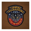 Embroidered patch with a cat design and text 'Turnpike Troubadours A Cat In The Rain' on a brown background