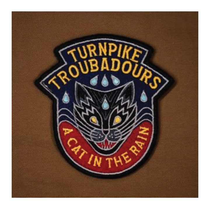 Embroidered patch with a cat design and text 'Turnpike Troubadours A Cat In The Rain' on a brown background