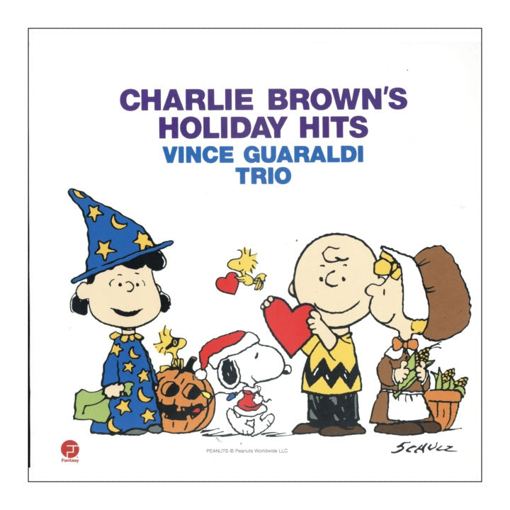 Vincent Guaraldi Trio's 'Charlie Brown's Holiday Hits' album cover, featuring classic Peanuts characters including Charlie Brown, Snoopy, Woodstock, and Lucy in festive holiday costumes against a white background.