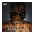Wiz Khalifa with intricate tattoos on the back, wearing a headwrap against a dark background.